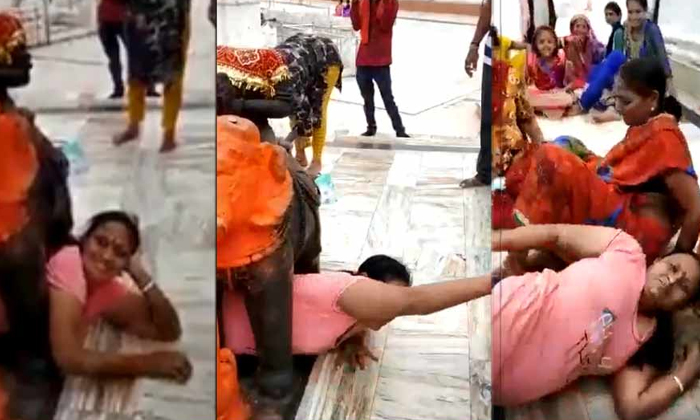  Tstop2women Stuck Under Elephant Statue-TeluguStop.com