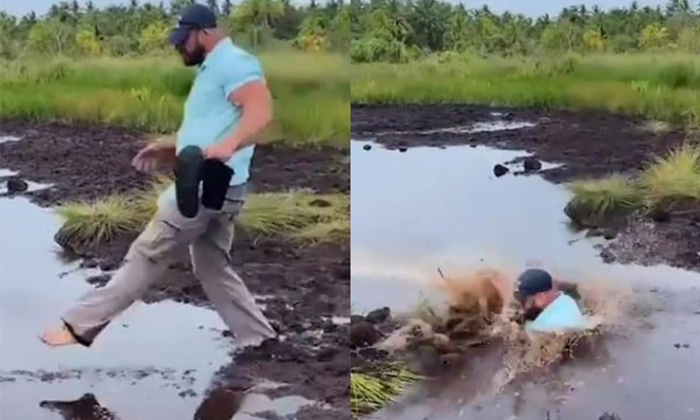  Hilarious Video Of Man Getting Very Muddy As He Attempts To Cross Swap Goes Vira-TeluguStop.com