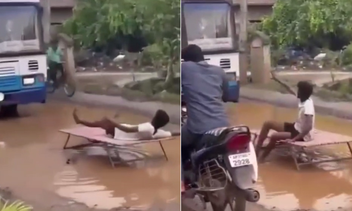  A Young Man Laying On A Bed On The Road Is A Protest, Protest, Variety Protest,-TeluguStop.com