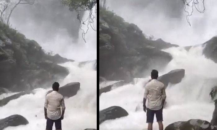  Viral Video: Leg Slipped While Standing On A Rock And Watching The Waterfall...-TeluguStop.com